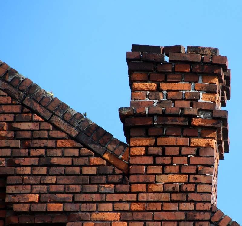 Damaged chimney on an Keego Harbor home showing cracks and missing mortar